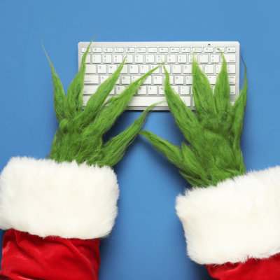 The Grinch typing on a keyboard